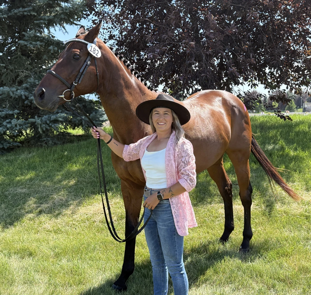 Woman with horse in sunny field